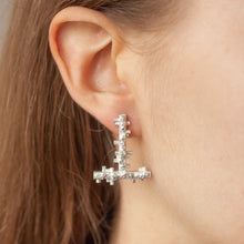 Load image into Gallery viewer, AMPLİFYY Silver Stud Earring with Green Sapphire on a model | CØLØNY Collection | Margo Orlovik Contemporary Jewellery