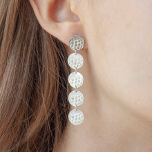 Load image into Gallery viewer, CONTINUUM Silver Long Earring with five textured circles on a model | IMPRINT Collection | Margo Orlovik Contemporary Jewellery