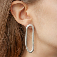 Load image into Gallery viewer, PARAGON COIL silver mismatched earrings on a model | Margo Orlovik IMPRINT Collection Contemporary Jewellery