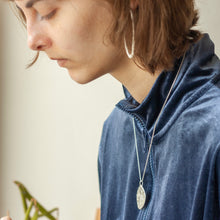 Load image into Gallery viewer, PARAGON II ROUND SILVER PENDANT WITH SQUARE PATTERN ON CHAIN BY MARGO ORLOVIK ON MODEL