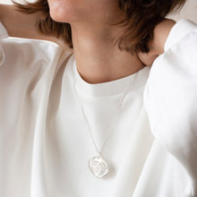 Load image into Gallery viewer, PARAGON I OVAL ORGANIC SHAPED SILVER PENDANT WITH SQUARE TEXTURE ON CHAIN BY MARGO ORLOVIK ON MODEL