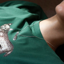 Load image into Gallery viewer, PARAGON VII ORGANIC OBLONG SILVER PENDANT WITH SQUARE PATTERN ON A CHAIN BY MARGO ORLOVIK ON A MODEL