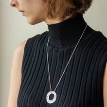 Load image into Gallery viewer, PARAGON VI ROUND SILVER PENDANT ON CHAIN BY MARGO ORLOVIK ON A MODEL