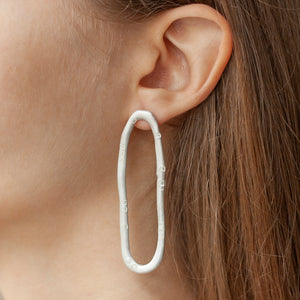 PARAGON COIL silver mismatched earrings  on a model | Margo Orlovik IMPRINT Collection Contemporary Jewellery