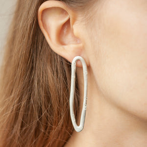 PARAGON DART silver mismatched earrings ON A MODEL | Margo Orlovik IMPRINT Collection Contemporary Jewellery