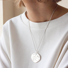 Load image into Gallery viewer, PARAGON I OVAL ORGANIC SHAPED SILVER PENDANT WITH SQUARE TEXTURE ON CHAIN BY MARGO ORLOVIK ON MODEL
