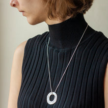 Load image into Gallery viewer, PARAGON VI ROUND SILVER PENDANT ON CHAIN BY MARGO ORLOVIK ON A MODEL 
