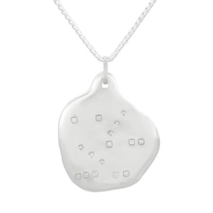 Organic shaped silver pendant with square pattern and white sapphires, on a chain.