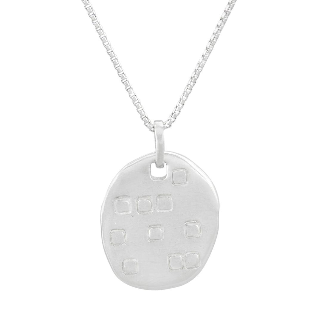 Organic shaped silver pendant with square pattern, on a chain.